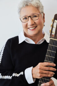 Ana Maria Rosado holding her guitar